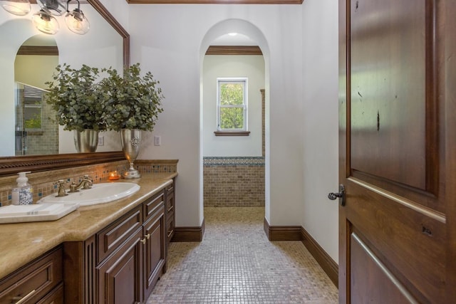 bathroom featuring tasteful backsplash, a shower with door, and vanity