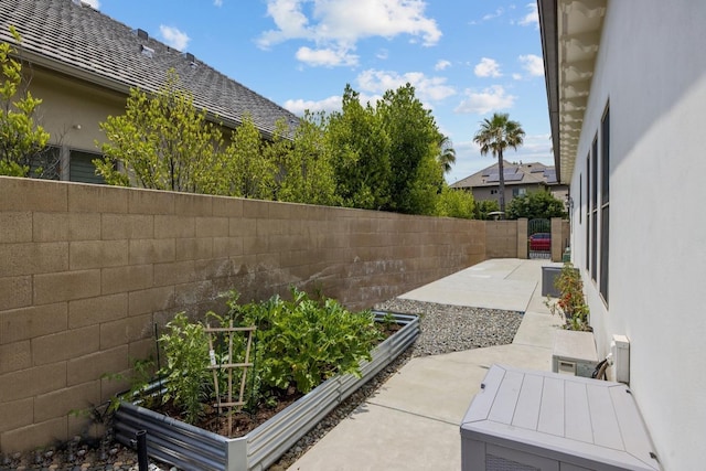 view of patio featuring a fenced backyard and a vegetable garden