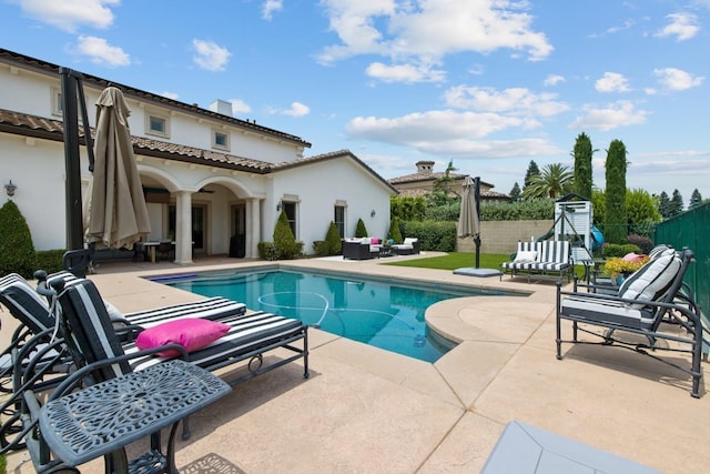 view of swimming pool featuring a fenced in pool, outdoor lounge area, a patio, and fence