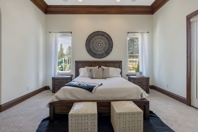 carpeted bedroom with multiple windows, baseboards, and crown molding