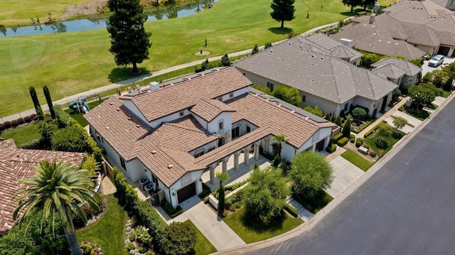 drone / aerial view with a water view and a residential view