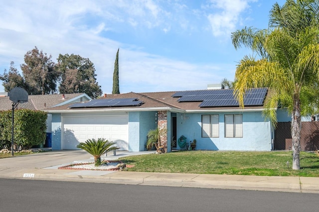 single story home featuring a garage, driveway, roof mounted solar panels, a front lawn, and stucco siding