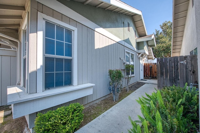 view of side of home with fence