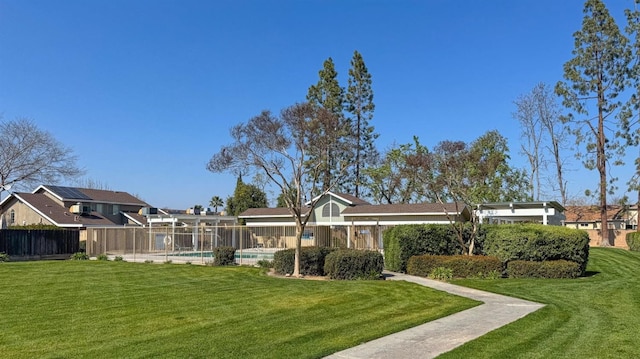 exterior space featuring a yard, a swimming pool, and fence