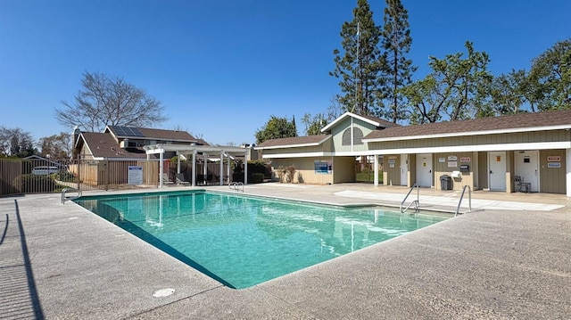 pool featuring a patio area and fence