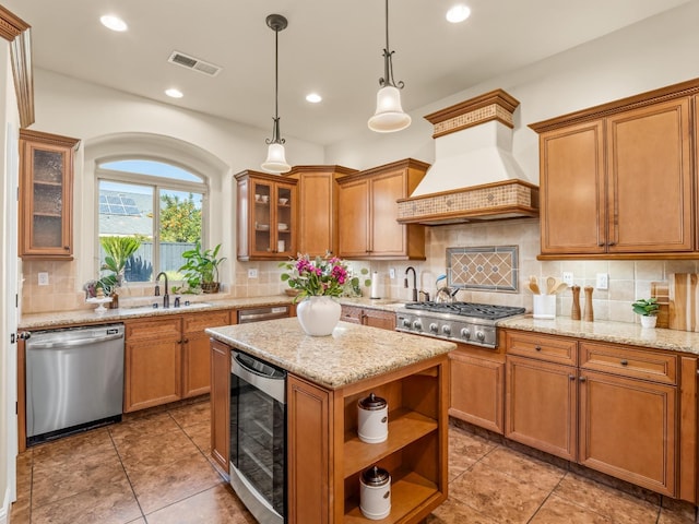 kitchen with visible vents, custom range hood, wine cooler, stainless steel appliances, and a sink