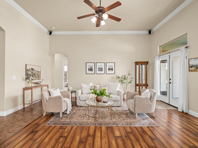 living area featuring arched walkways, plenty of natural light, and wood finished floors