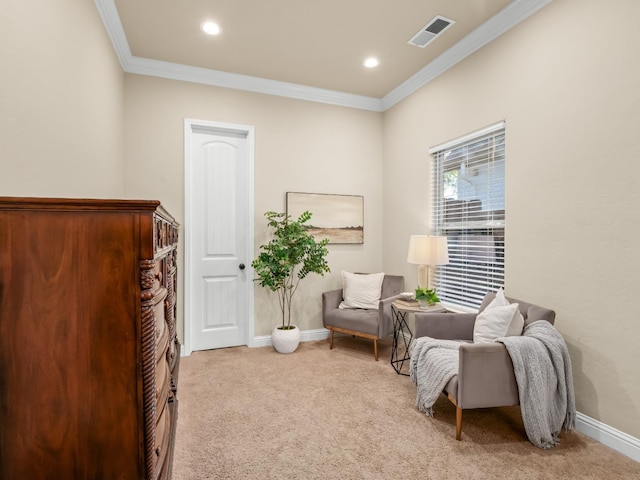 living area with light colored carpet, visible vents, crown molding, and baseboards