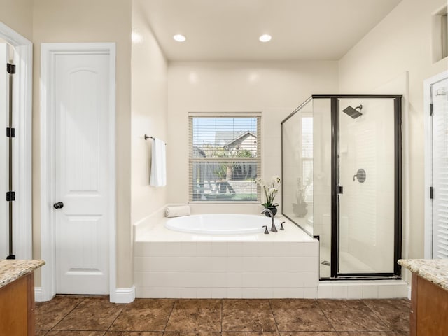 full bathroom with a stall shower, vanity, and a bath