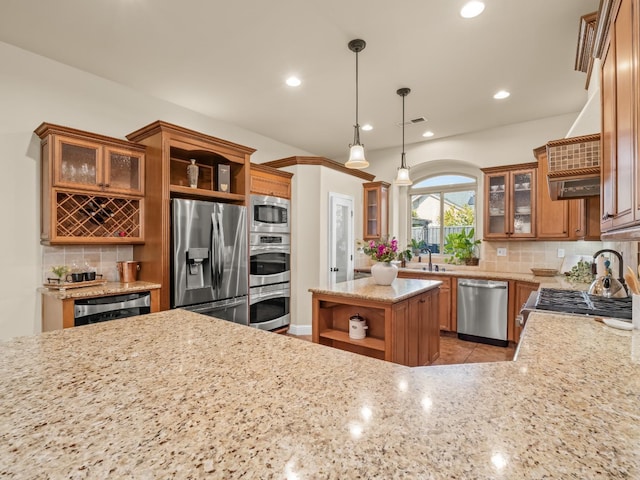 kitchen with appliances with stainless steel finishes, tasteful backsplash, brown cabinetry, and open shelves