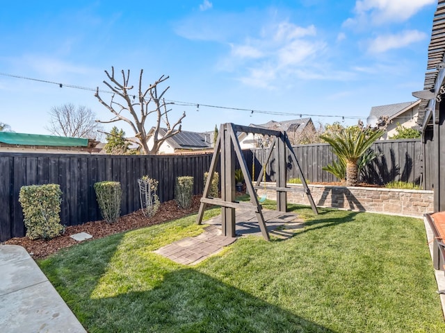 view of play area featuring a fenced backyard and a lawn