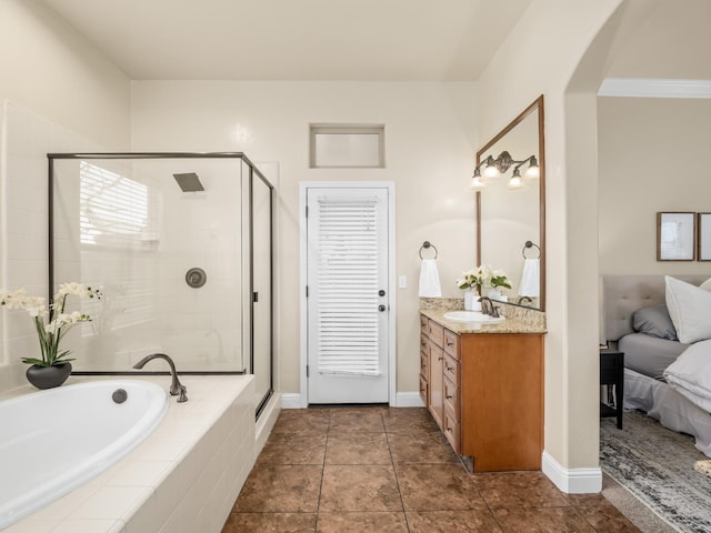 full bath featuring a garden tub, a shower stall, baseboards, and vanity