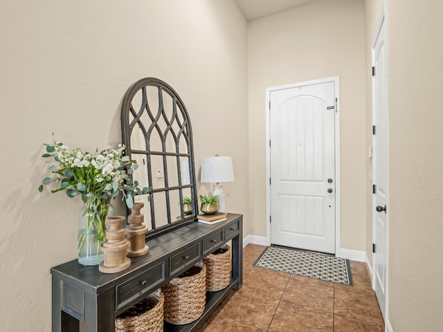 foyer entrance with tile patterned flooring and baseboards