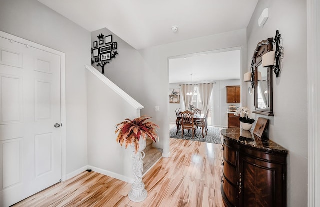 foyer featuring light wood-type flooring and baseboards