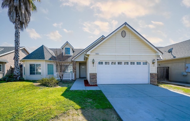 view of front of property with an attached garage, stone siding, concrete driveway, and a front yard