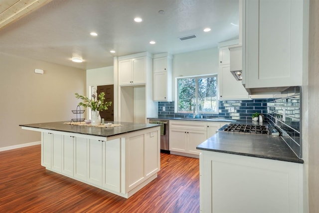 40865 Cold Springs Ln, Shaver Lake, CA 93664 - kitchen featuring dark countertops, dark wood-style flooring, decorative backsplash, white cabinets, and a sink