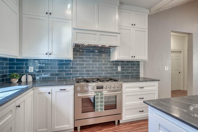 40865 Cold Springs Ln, Shaver Lake, CA 93664 - kitchen with gas range, backsplash, premium range hood, and white cabinets