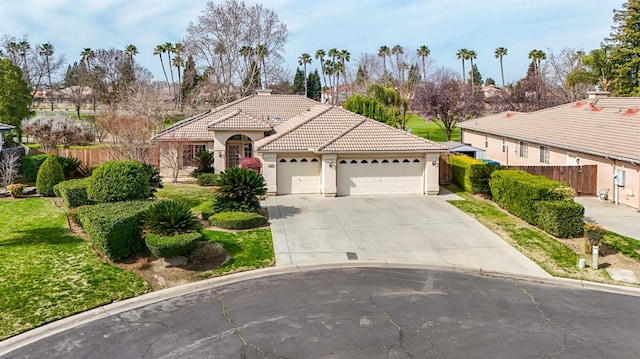 view of front of house featuring stucco siding, concrete driveway, fence, a garage, and a tiled roof