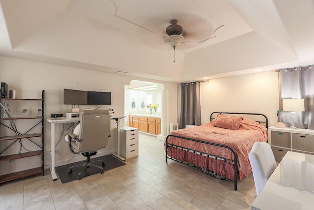 bedroom featuring ceiling fan and a tray ceiling