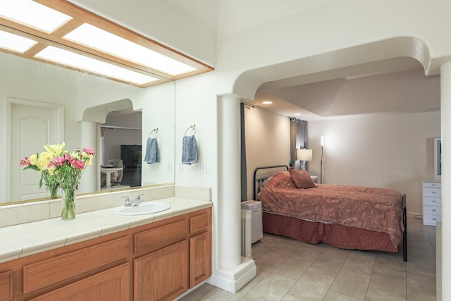 bathroom with tile patterned floors and vanity