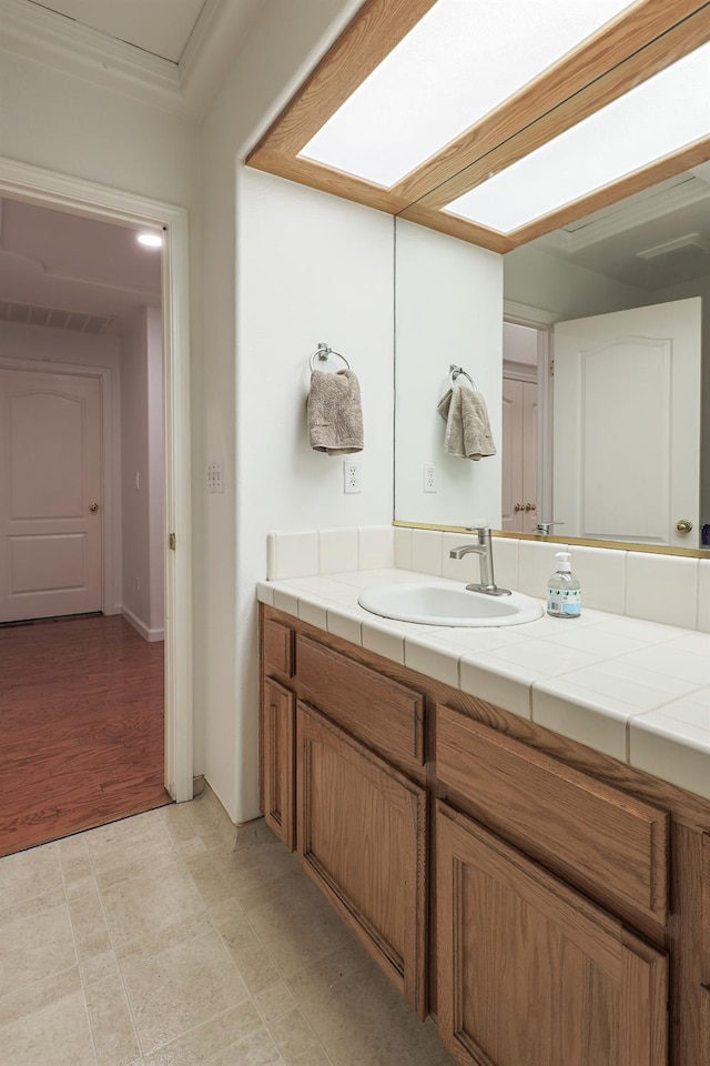 bathroom with a skylight and vanity