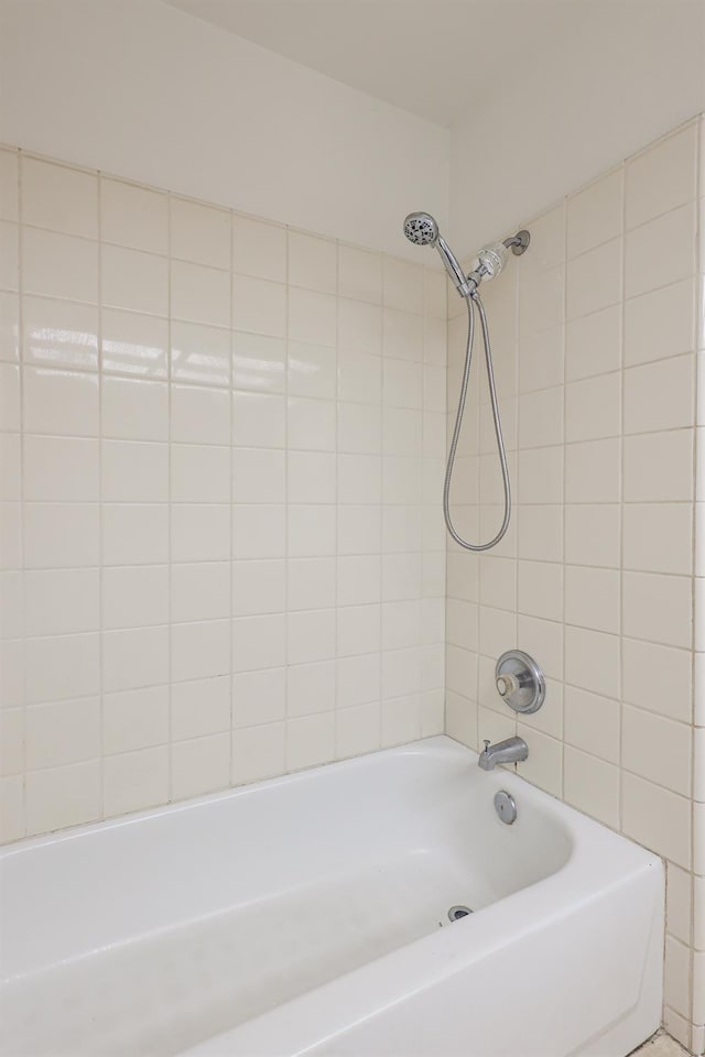 bathroom with shower / washtub combination