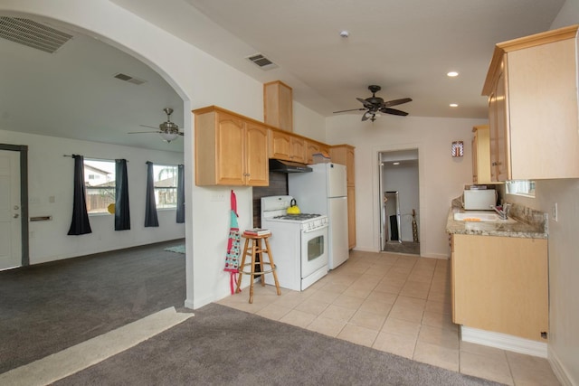 kitchen featuring light colored carpet, white appliances, visible vents, and under cabinet range hood