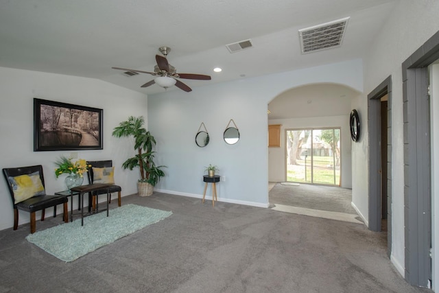 sitting room featuring carpet floors, arched walkways, visible vents, and recessed lighting