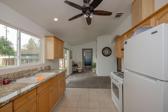 kitchen featuring light countertops, white appliances, visible vents, and light carpet