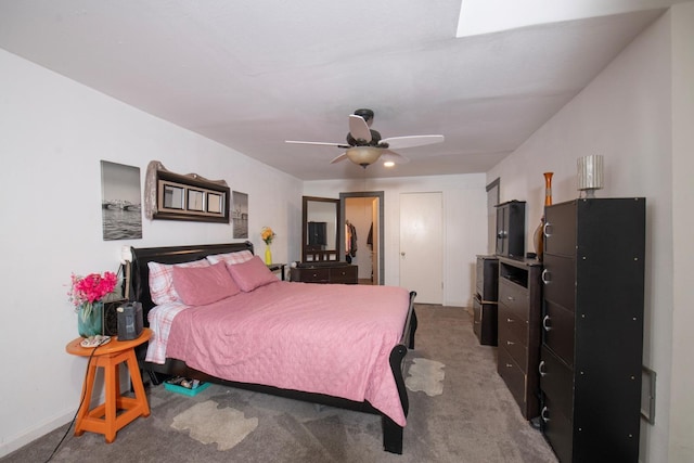 carpeted bedroom with ceiling fan and baseboards