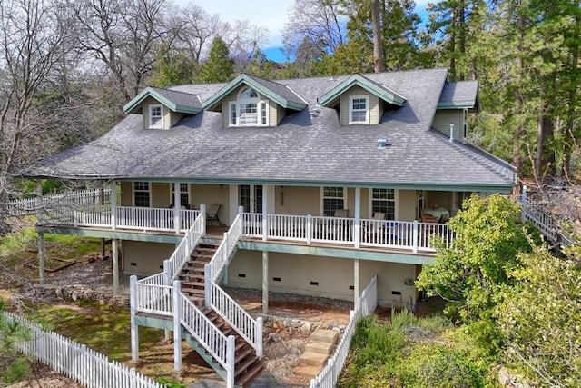 coastal inspired home featuring crawl space, stairway, fence, and covered porch