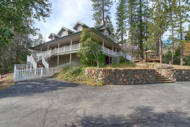 view of front of property with covered porch and stairway