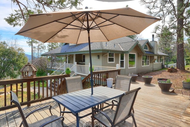 wooden terrace with outdoor dining area