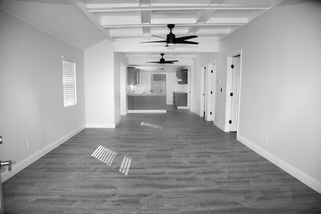 unfurnished living room featuring dark wood-style floors, a ceiling fan, baseboards, and beamed ceiling