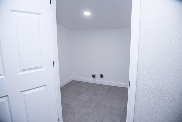 laundry area featuring laundry area, baseboards, and electric dryer hookup