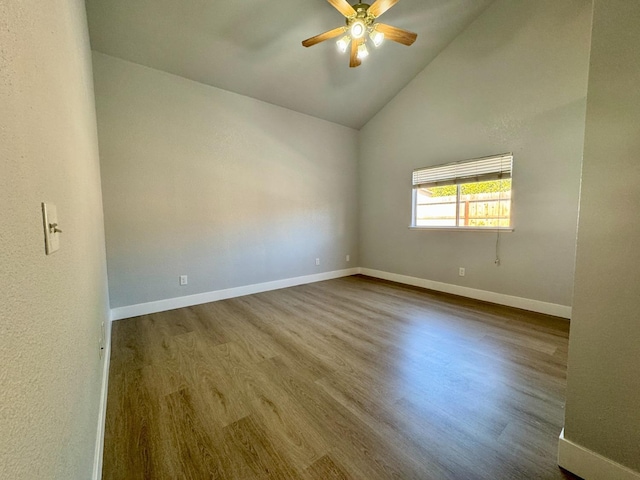 unfurnished room featuring high vaulted ceiling, ceiling fan, baseboards, and wood finished floors