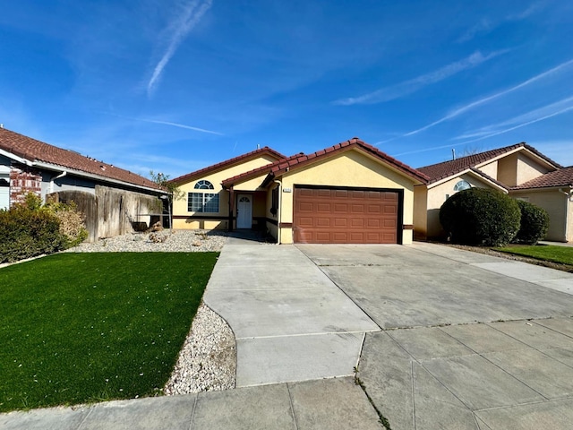 view of front facade featuring concrete driveway, a tiled roof, an attached garage, a front lawn, and stucco siding