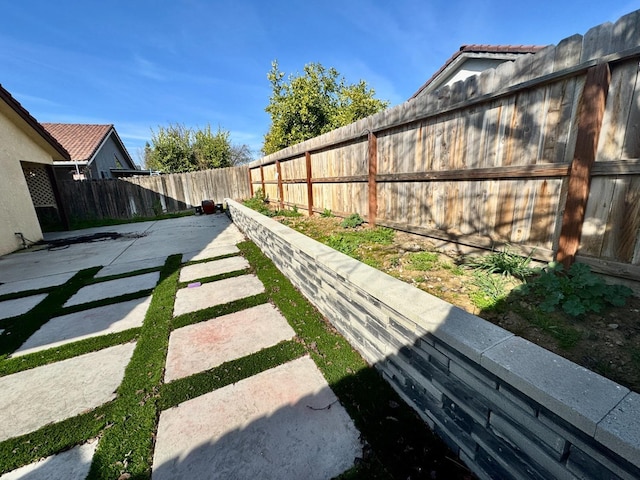 view of yard with a fenced backyard and a patio