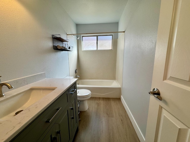 full bath featuring shower / bathing tub combination, toilet, vanity, wood finished floors, and baseboards