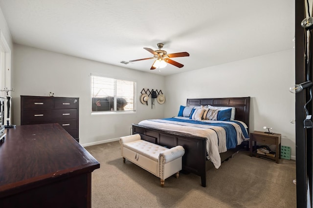 bedroom with a ceiling fan, baseboards, visible vents, and carpet flooring