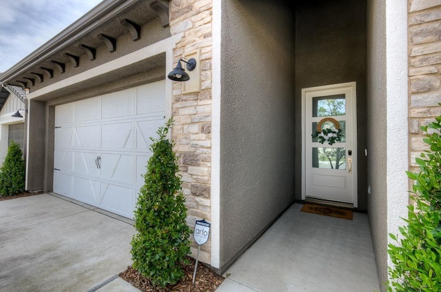 entrance to property with stone siding and stucco siding