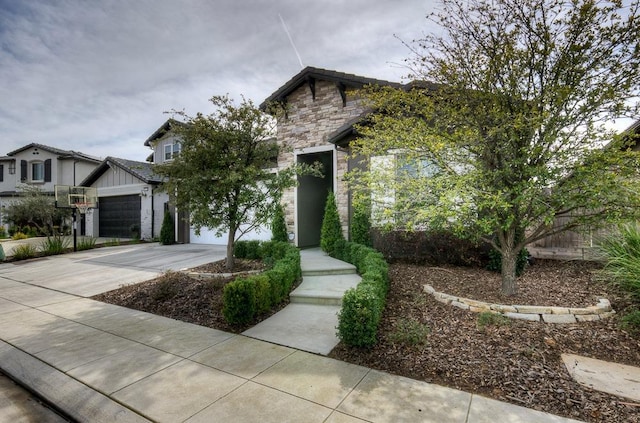 view of front facade featuring stone siding and concrete driveway