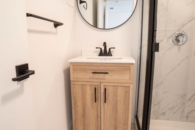 full bathroom with a shower stall and vanity