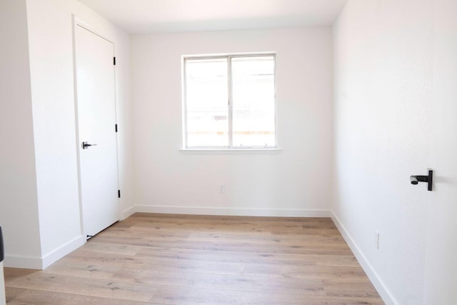 unfurnished bedroom featuring baseboards and light wood finished floors