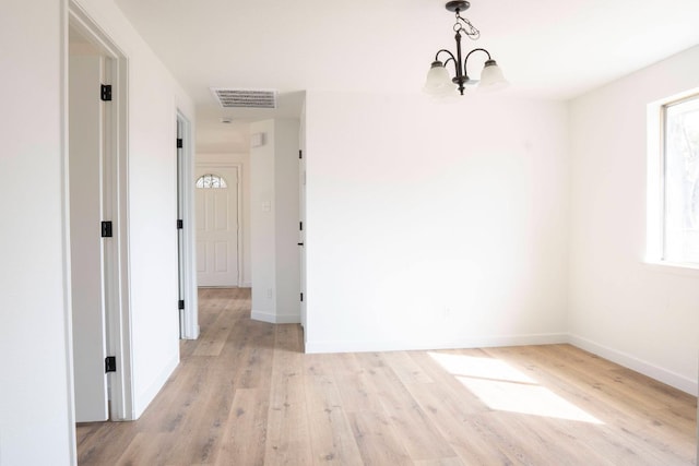 unfurnished dining area with visible vents, baseboards, and wood finished floors