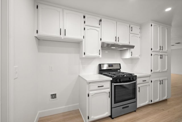 42906 Ranger Circle Dr Drive, Coarsegold, CA 93614 - kitchen with light wood-style flooring, under cabinet range hood, white cabinetry, light countertops, and stainless steel gas stove