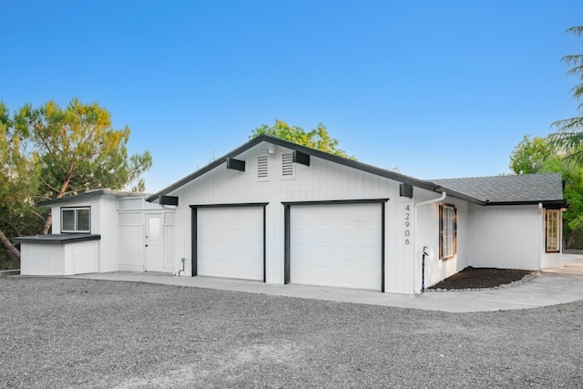 view of front of house with an attached garage and a shingled roof