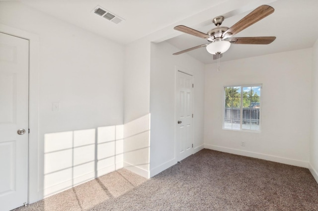 unfurnished room with visible vents, carpet flooring, baseboards, and ceiling fan