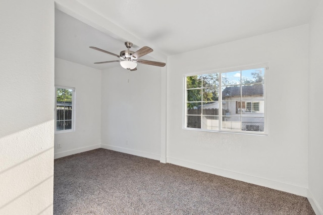 unfurnished room with ceiling fan, baseboards, and carpet