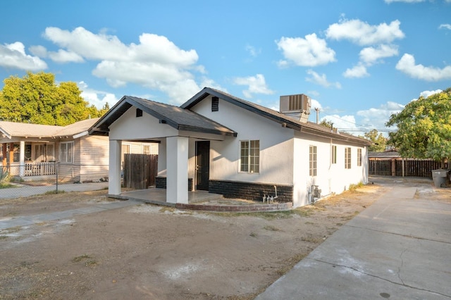 exterior space with a patio area, fence, central AC, and stucco siding